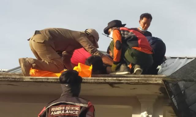 Petugas melakukan evakuasi jasad Nordiansyah yang tewas kesetrum saat memperbaiki kabel listri di atas plafon di Jalan Bondol XIII Palangka Raya, Sabtu (10/4/2021) sore