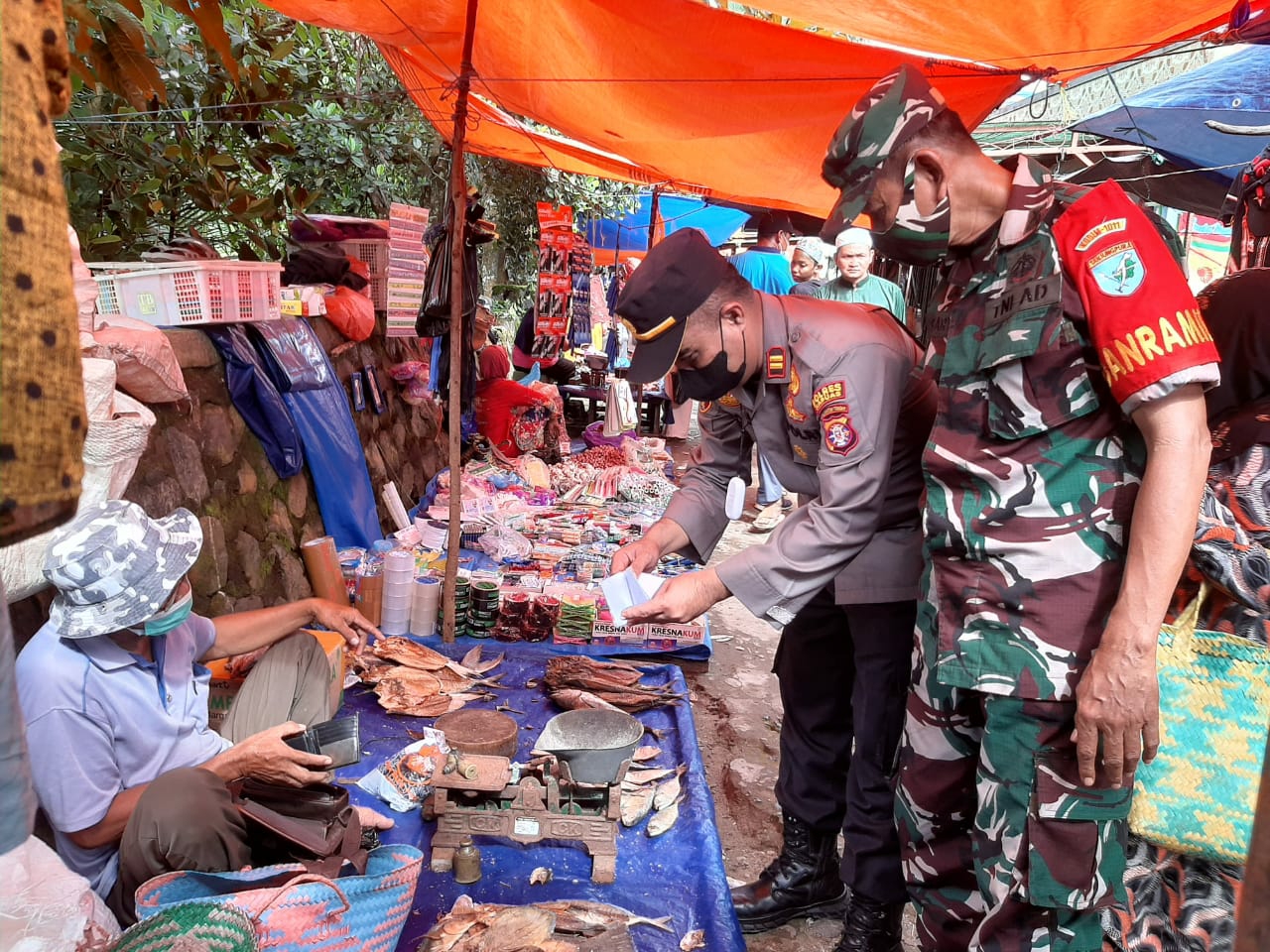 Kapolsek bersama Danramil saat memeriksa kartu vaksinasi pedagang